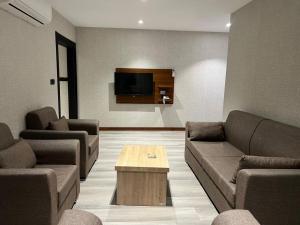 a living room with couches and a coffee table at زاده هوتيل - Zade Hotel in Duhok