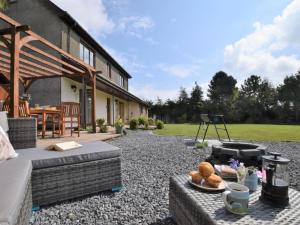 a backyard with a fire pit and a house at 3 Bed in Brecon oc-83076 in Aber-Brân