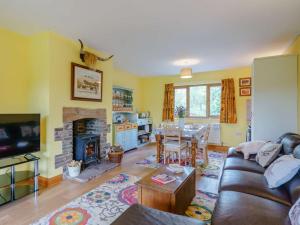 a living room with a couch and a dining room at 3 Bed in Brecon oc-83076 in Aber-Brân