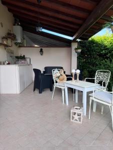 a patio with a white table and chairs at CasaEma in Torre del Lago Puccini