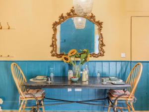 a dining room with a table with a mirror and chairs at 1 Bed in Chulmleigh oc-88862 in Chawleigh