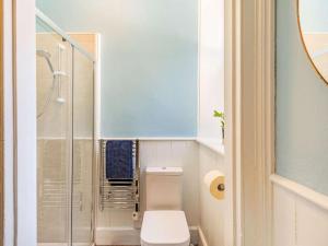 a bathroom with a toilet and a glass shower at 1 Bed in Chulmleigh oc-88862 in Chawleigh