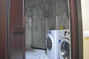a washing machine in a bathroom with a shower at Apartament 2 in Gonio