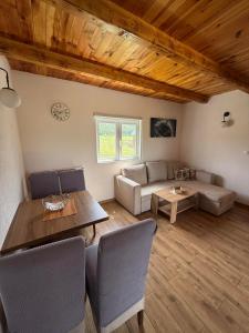 a living room with a couch and a table at Bungalovi 3AS in Žabljak