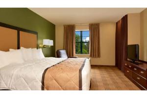 a hotel room with a bed and a television at Studio 6 Extended Stay Fairfield, OH - Cincinnati in Fairfield