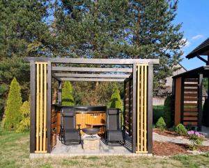 a gazebo with a grill in a yard at Agroturystyka Jagodowa Róża in Mszana Dolna