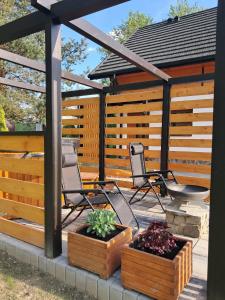 a patio with two chairs and a gazebo at Agroturystyka Jagodowa Róża in Mszana Dolna +81 photos