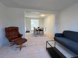 a living room with a couch and a table at Møllevej in Hjørring +12 photos