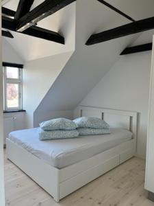 a bedroom with a bed with two pillows on it at Møllevej in Hjørring