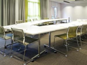 a conference room with a large table and chairs at Novotel Constantine in Constantine