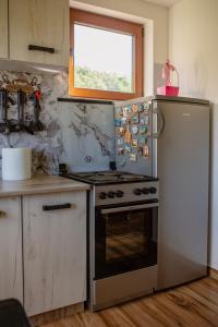 a kitchen with a stove and a refrigerator at Mountain Home Zaborje in Plužine +19 photos