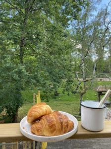 a plate with a loaf of bread on a table at Maison Joviale in La Ferté-Saint-Aubin