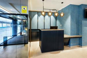 a lobby with a desk with a laptop on it at Sercotel Ayala in Bilbao