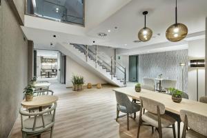 an office lobby with tables and chairs and stairs at Sercotel Ayala in Bilbao