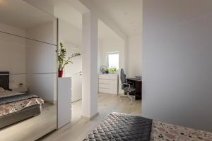 a bedroom with a bed and a desk at Apartment Stocic in Rogoznica