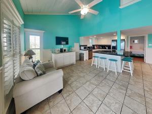 a living room with a couch and a kitchen at Sundancers in Galveston
