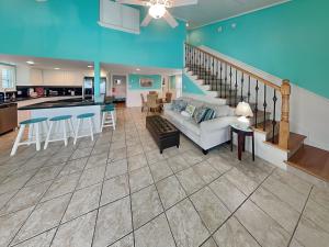 a large living room with a couch and a kitchen at Sundancers in Galveston