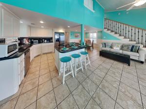 a large kitchen and living room with a couch at Sundancers in Galveston