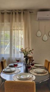 a dining room table with glasses of red wine at Apartman Mara in Risan