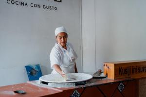a chef is making a pizza on a table at Parador del Dominico in Oaxaca City