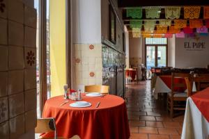a table with a red table cloth in a restaurant at Parador del Dominico in Oaxaca City