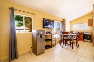 a kitchen and dining room with a table and a refrigerator at Beach Studio 7 in San Felipe