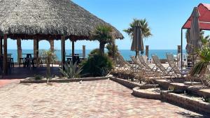 a beach with chairs and an umbrella and the ocean at Beach Studio 7 in San Felipe