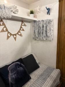a cat pillow on a bed in a bedroom at Králíkova chatka in Kaliště