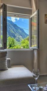 a window with a view of a mountain view at Apartman Mara in Risan