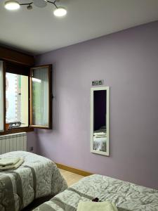 a bedroom with two beds and two windows at Apartamento Oteixon in Narvarte