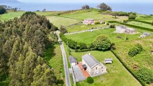 an aerial view of a house on a hill at The Cliffs - Casa Cadaval in Santa Marta de Ortigueira