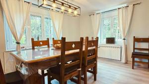 a dining room with a table and chairs and windows at The Cliffs - Casa Cadaval in Santa Marta de Ortigueira +91 photos
