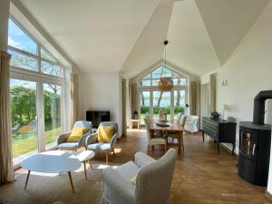 a living room with chairs and a table at Schlei Resort Marina Hülsen in Kosel