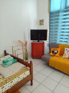 a living room with a couch and a tv at Manolia !!! in Kranidi
