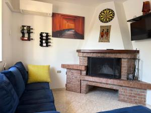 a living room with a couch and a fireplace at Happy's Casa in Putignano
