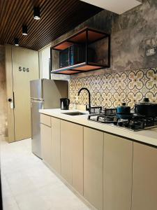 a kitchen with a stove and a counter top at LOS ARCES HOTEL in Lima