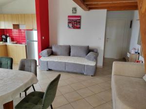 a living room with a couch and a kitchen at Apartment Lighthouse n3 in Fažana +12 photos