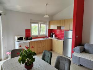 a kitchen with a white refrigerator and a table with chairs at Apartment Lighthouse n3 in Fažana