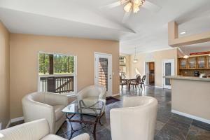 a living room with white chairs and a table at 200 Acres, River Access: 'Feather House' in NorCal in Sloat