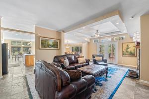 a living room with a leather couch and a table at 200 Acres, River Access: 'Feather House' in NorCal in Sloat