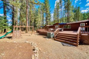 a log cabin with a playground and a house at 200 Acres, River Access: 'Feather House' in NorCal in Sloat