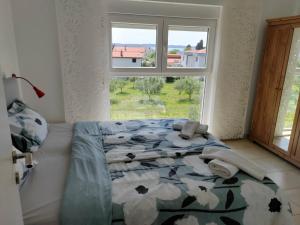 a bedroom with a bed and a window with a view at Apartment Lighthouse n3 in Fažana