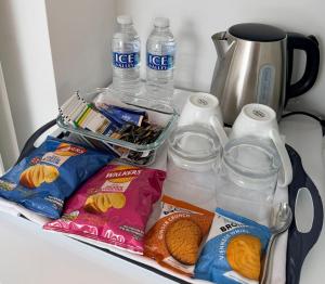 a refrigerator filled with milk and food and drinks at Ardbrin Lodge Guest Accommodation in Dunadry