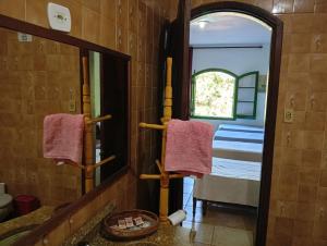 a bathroom with a mirror and a bed at Pousada rotas e ritmos in São Paulo +45 photos
