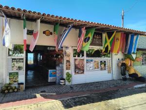 a store with colorful flags on the front of it at Pousada Solar da Costa 1908 quarto com banheiro in Serra