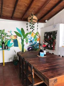 a dining room with a wooden table and plants at The Best Adventure Hostel in San Gil