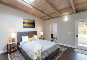 a bedroom with a bed and two tables with lamps at 3890 Cypress Rest in Pebble Beach