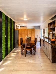 a dining room with a table and chairs in a kitchen at Polokwane Luxury Guest House in Polokwane
