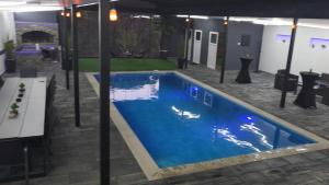 a pool in the middle of a room with a building at Vikendica Tuzla baracuda bazen in Slavinovići +2 photos