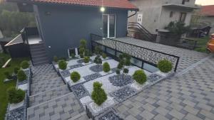 a house with a patio with plants on it at Vikendica Tuzla baracuda bazen in Slavinovići